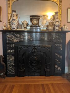When the Avery-Copp House was first built circa 1800 fireplaces were once the main heat source of each room. By the early 1900s when they were no longer needed for heat they were blocked to prevent heat loss. This fireplace is in the parlor which is the fanciest room of the house and it was blocked to match the rest of the elaborate décor of the room.